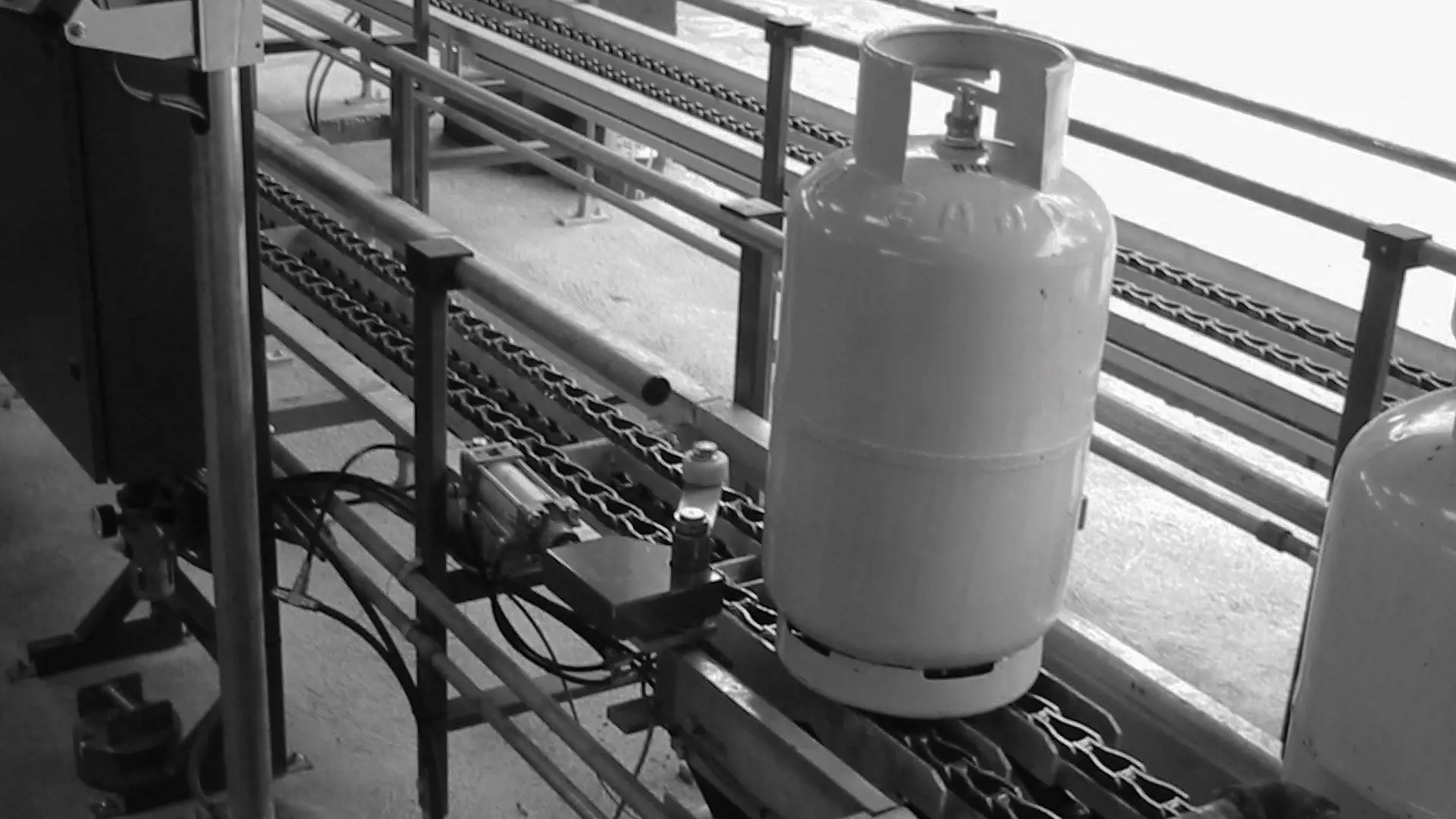 Chain conveyor Image of a chain conveyor with an LPG cylinder on it