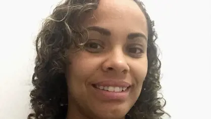 Portrait of a woman with brown curled hair CPJ